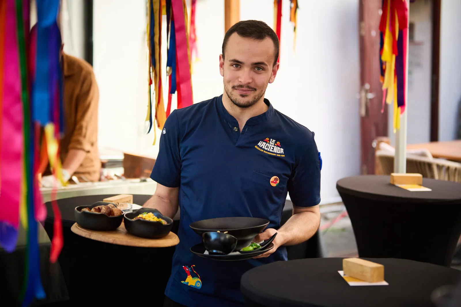 Precise waiter serving food at a corporate event